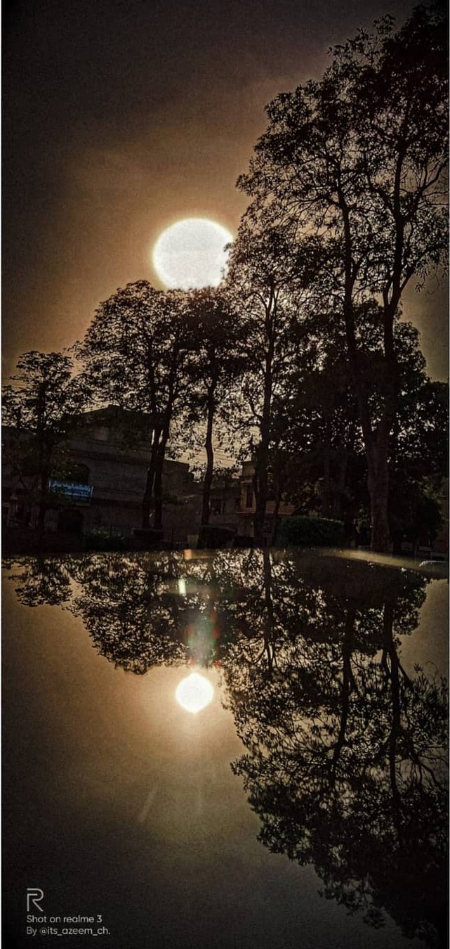 Moonrise, Mirrored — golden hour photograph by Muhammad Azeem