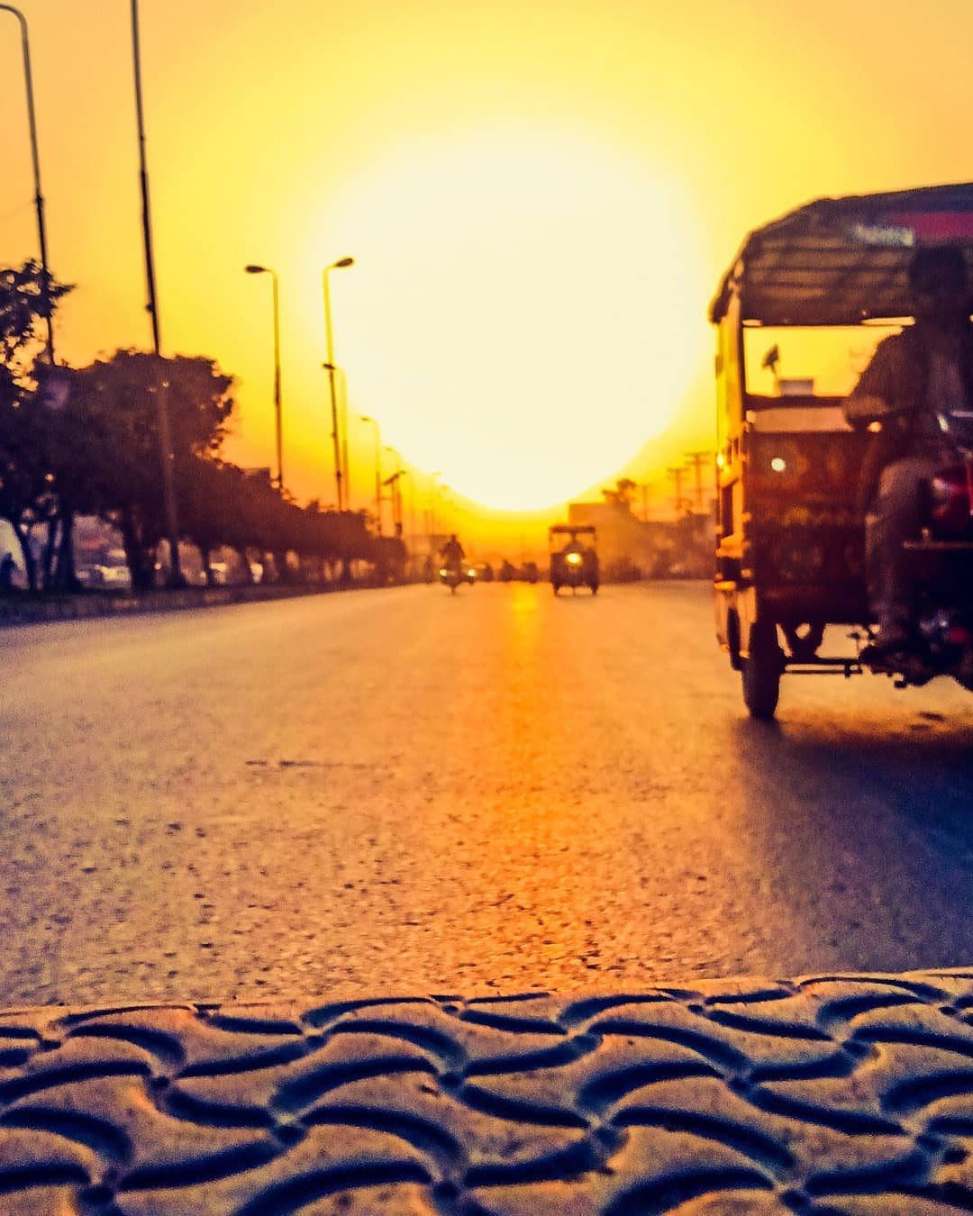 Rickshaw into the Sun — golden hour photograph by Muhammad Azeem
